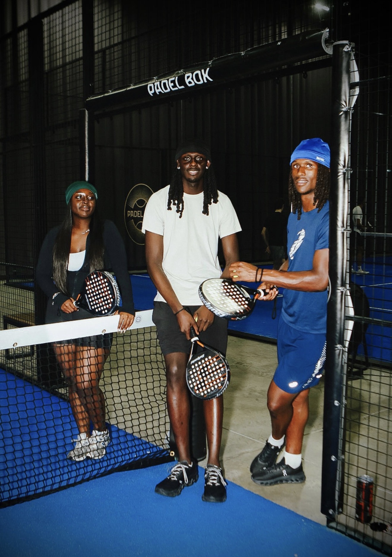 NOIR skull caps in green, black and blue worn on the padel court